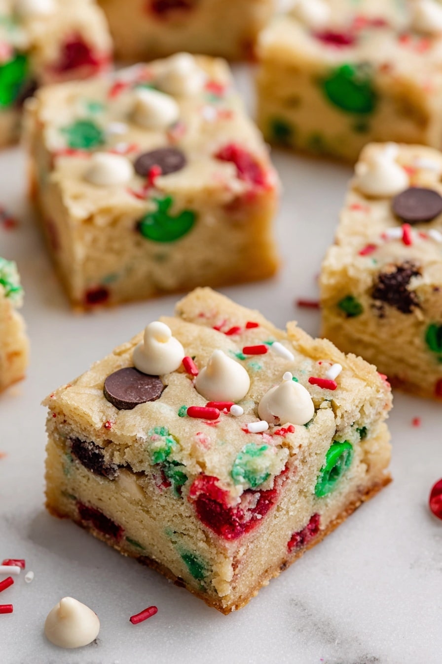 Christmas Cookie Bars, festive cookie bars, easy holiday treats, no-bake Christmas desserts, candy-filled cookie bars - The image shows square pieces of soft, light-colored cookie bars spread out on a white marbled surface. Each bar has two layers: a thick, slightly crumbly beige cookie base studded with colorful red and green candy pieces, along with dark and white chocolate chips scattered evenly throughout. The top layer is the same cookie dough with visible embedded candy and chips, giving a festive look. Small white and red sprinkles are also scattered on the surface of the bars. Photo taken with an iphone --ar 2:3 --v 7
