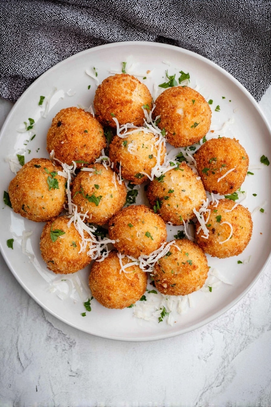 Crispy Mashed Potato Balls with Cheddar and Green Onions, cheesy crispy potato bites, savory mashed potato snacks, easy cheesy potato appetizers, homemade crispy potato balls - A close view of one bright golden brown fried ball being pulled apart by two woman's hands, revealing a soft, cheesy white inside with bits of green herbs mixed in, and a slight stringy cheese pull between the two halves. In the background, many more similar golden brown fried balls with small green herb pieces are scattered on a white plate, all set on a white marbled surface. photo taken with an iphone --ar 2:3 --v 7