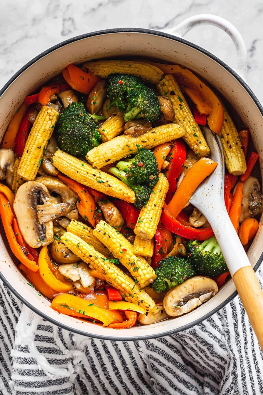 Vegetable Stir Fry, Quick Vegetable Stir Fry, Healthy Veggie Stir Fry, Easy Stir Fry Dinner, Vibrant Vegetable Stir Fry - A white pot holds a colorful mix of vegetables with three main layers: at the bottom are light brown sliced mushrooms with a tender texture, the middle layer shows bright green broccoli florets with a slightly rough surface, and the top layer is filled with long baby corn with a yellow bumpy surface, bright orange carrot slices, and strips of red and yellow bell peppers, all glistening with a light sauce and sprinkled with small green herb flakes and black pepper. A white spoon with a wooden handle is resting inside the pot, partly lifting some of the vegetables. The pot sits on a white marbled surface next to a white and black striped cloth. Photo taken with an iphone --ar 2:3 --v 7