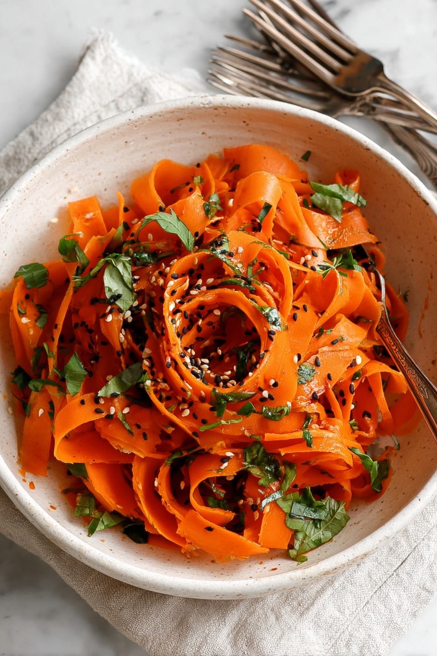 Raw Carrot Salad with Parsley and Balsamic-Vinegar Dressing, healthy carrot salad, fresh vegetable salad, quick vegan salad, easy summer side dish - A white bowl filled with thin, long orange carrot ribbons that are twisted and curled loosely in layers. The carrot ribbons have a shiny texture and are scattered with small pieces of green leafy herbs and black and white sesame seeds sprinkled on top. The bowl sits on a white marbled surface with a light cloth and two antique silver forks nearby. Photo taken with an iphone --ar 2:3 --v 7