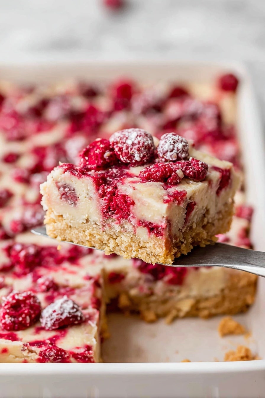 Cranberry Christmas Cake, holiday cranberry cake, festive cake with cranberries, holiday dessert recipes, easy Christmas cake - A square piece of dessert with three clear layers is being lifted by a spatula. The bottom layer is a golden, crumbly crust with a slightly rough texture. The middle layer is smooth and pale beige, forming a solid base. The top layer is a mix of bright red berries scattered inside a light, creamy topping that has a soft, slightly uneven texture with small bubbles and a dusting of sugar crystals. The dessert sits in a white baking pan, and the background shows the rest of the dessert still inside the pan, all placed on a white marbled surface. photo taken with an iphone --ar 2:3 --v 7