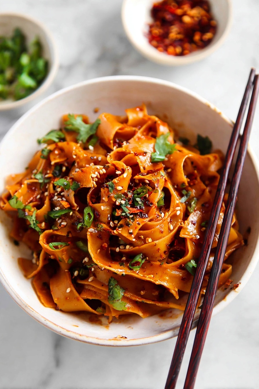 Spicy Chili Garlic Noodles, chili garlic noodle dish, spicy Asian noodles, quick garlic noodle recipe, fiery stir-fry noodles - The image shows a white pot filled with four layers of wide, flat noodles cooked in a dark brown sauce, giving the noodles a shiny and rich look. Scattered over the noodles are small pieces of green herbs and tiny bits of red chili pepper, adding a touch of color and texture. The noodles are swirled and mixed together with some areas appearing thicker and some thinner, showing a soft and smooth texture. The pot sits on a white marbled surface with a pair of dark brown chopsticks resting beside it. Nearby, there is a small white bowl filled with red chili flakes. Photo taken with an iphone --ar 2:3 --v 7