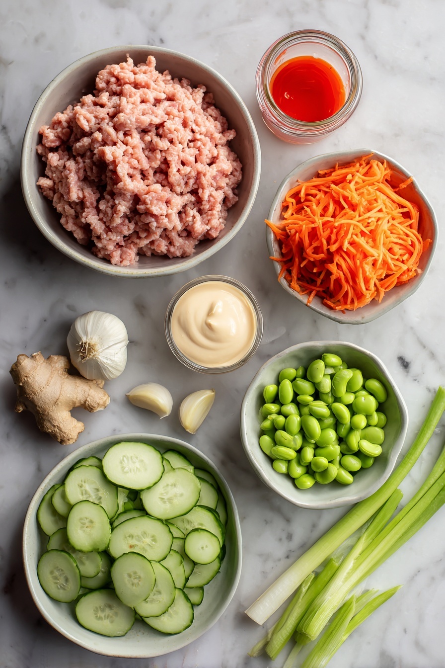 Ground Turkey Rice Bowls with Bang Bang Sauce, ground turkey rice bowls, easy dinner recipes, spicy Asian sauce meals, quick weeknight dinners - Flat lay of ground turkey raw and fresh, peeled garlic cloves, fresh ginger root with a small piece grated, bright orange shredded carrots, sliced green onions with vibrant green tops, sliced avocado with creamy green flesh, shelled edamame beans, small jar of creamy mayonnaise, and a small bowl of bright red sweet chili sauce with sriracha drizzle, all placed on a white marble surface, photo taken with an iphone --ar 2:3 --v 7