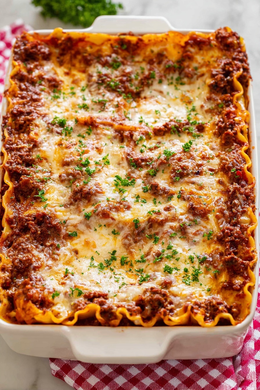 Easy Beef Lasagna, classic beef lasagna, homemade lasagna recipe, comforting dinner ideas, easiest lasagna for beginners - A white rectangular baking dish holds a thick lasagna with about five layers visible; the bottom layer is flat orange pasta sheets, followed by a rich dark brown meat sauce, then another layer of pasta, meat sauce, and a top layer covered in melted golden cheese with brown spots. Small bits of fresh green parsley are sprinkled evenly on top, adding a fresh touch. The dish sits on a red and white checkered cloth over a white marbled surface. photo taken with an iphone --ar 2:3 --v 7