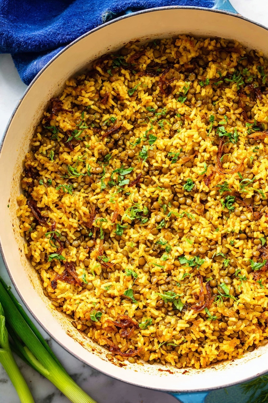 Mujadara Lentils and Rice, Middle Eastern lentil and rice dish, delicious lentils and rice recipe, smoky caramelized onion Mujadara, nourishing healthy lentil recipe - The image shows a white round pot filled with a mixed dish made of cooked yellow rice and small green lentils, combined with pieces of light brown caramelized onions and chopped green herbs scattered throughout. The texture looks soft and slightly moist with some grains sticking together and a few small charred spots seen inside the pot. The pot is placed on a white marbled surface with a blue cloth partly visible under its handle, and some green onions lay next to the pot on the lower left side. The lighting highlights the warm golden tones of the rice and the fresh green color of the herbs, creating a vibrant and appetizing look. photo taken with an iphone --ar 2:3 --v 7