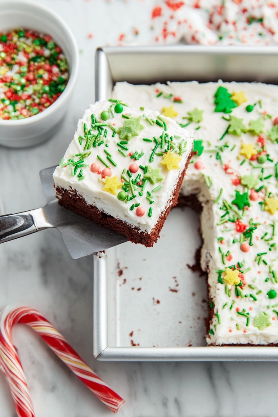 Christmas Red Velvet Lasagna Dessert, festive red velvet dessert, holiday layered dessert, Christmas lasagna recipes, colorful holiday desserts - A square piece of cake with two layers is lifted by a spatula above a white marbled surface. The cake’s bottom layer is chocolate brown, and the top is a thick white frosting spread evenly. The frosting is decorated with various colorful sprinkles, including green thin rods, small round pearls in pastel colors, yellow star shapes, and green Christmas tree shapes with red round sprinkles. The cake is in a silver baking pan with one piece missing from it. Nearby, there is a white bowl filled with green, red, and white holiday sprinkles. Two candy canes lie on the white marbled surface below the pan. Photo taken with an iphone --ar 2:3 --v 7