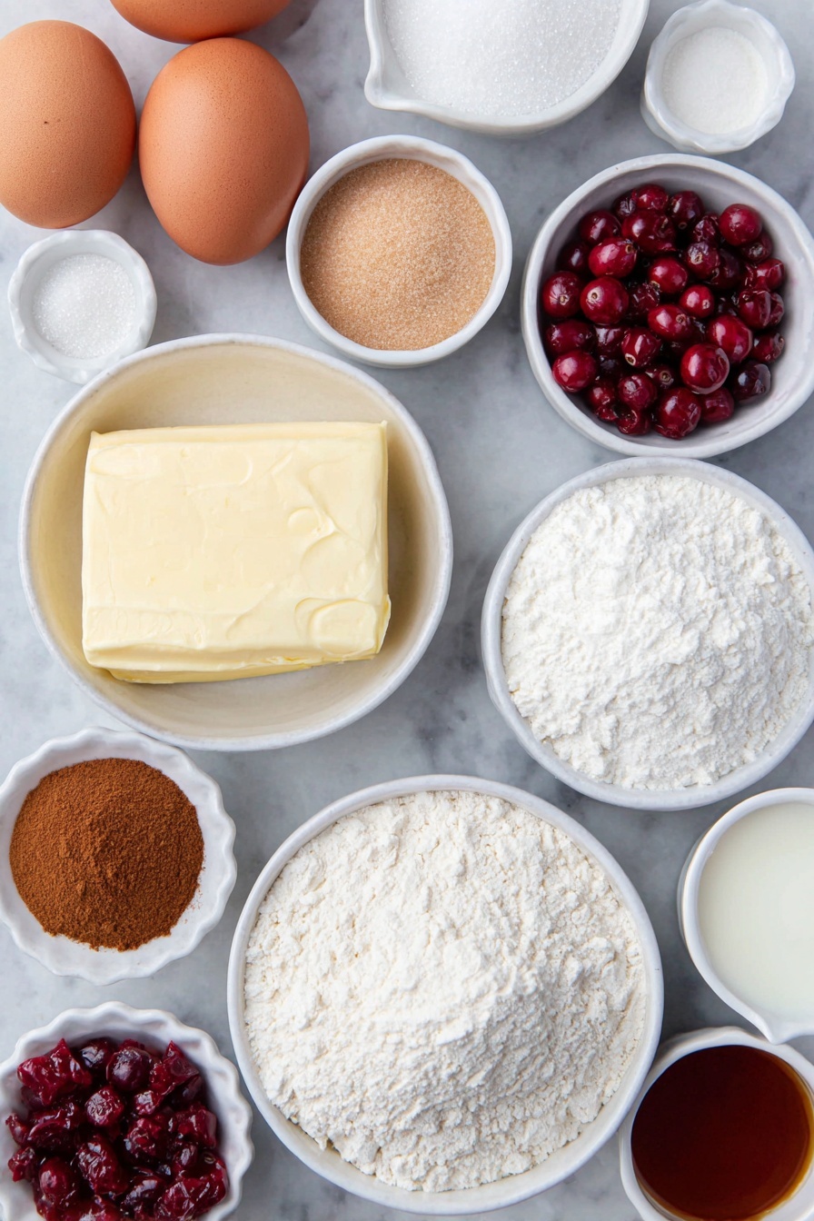 Cranberry Crumble Bars with Shortbread, cranberry crumble bars, shortbread bar dessert, cranberry tart bars, easy holiday fruit bars - Flat lay of fresh unsalted butter in a small white ceramic bowl, two brown eggs with clean shells, a small white bowl filled with granulated sugar, a small white bowl of light brown packed sugar, a small white bowl of sifted powdered sugar, a small white bowl of all-purpose flour, a small white bowl of baking powder, a small white bowl of ground cinnamon, a small white bowl of kosher salt, a small white bowl of cornstarch, a handful of fresh bright red cranberries, a few strands of orange zest next to a small white bowl of fresh orange juice, a small white bowl of vanilla extract, and a small white bowl of whole milk, all evenly spaced and arranged symmetrically on a clean white marble surface, soft natural light, photo taken with an iPhone, professional food photography style, fresh ingredients, white ceramic bowls, no bottles, no duplicates, no utensils, no packaging --ar 2:3 --v 7 --p m7354615311229779997