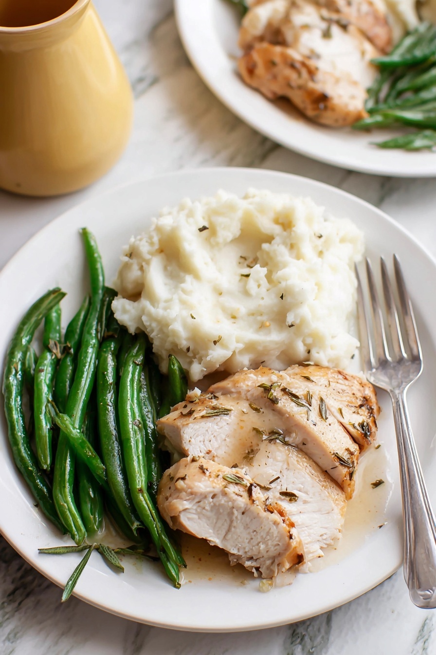 Easy Turkey Gravy, Turkey Gravy Recipe, How to Make Turkey Gravy, Homemade Turkey Gravy, Rich Turkey Gravy - A white plate holds three main parts: on the left, green beans with a shiny, fresh texture; in the middle front, sliced cooked chicken with a light brown, slightly crispy skin and some herb seasoning; on the right, a large scoop of white mashed potatoes with a soft, fluffy texture, and a silver fork resting at the edge of the plate. The plate sits on a white marbled surface, with a blurred second plate in the back and part of a yellow jug visible. photo taken with an iphone --ar 2:3 --v 7