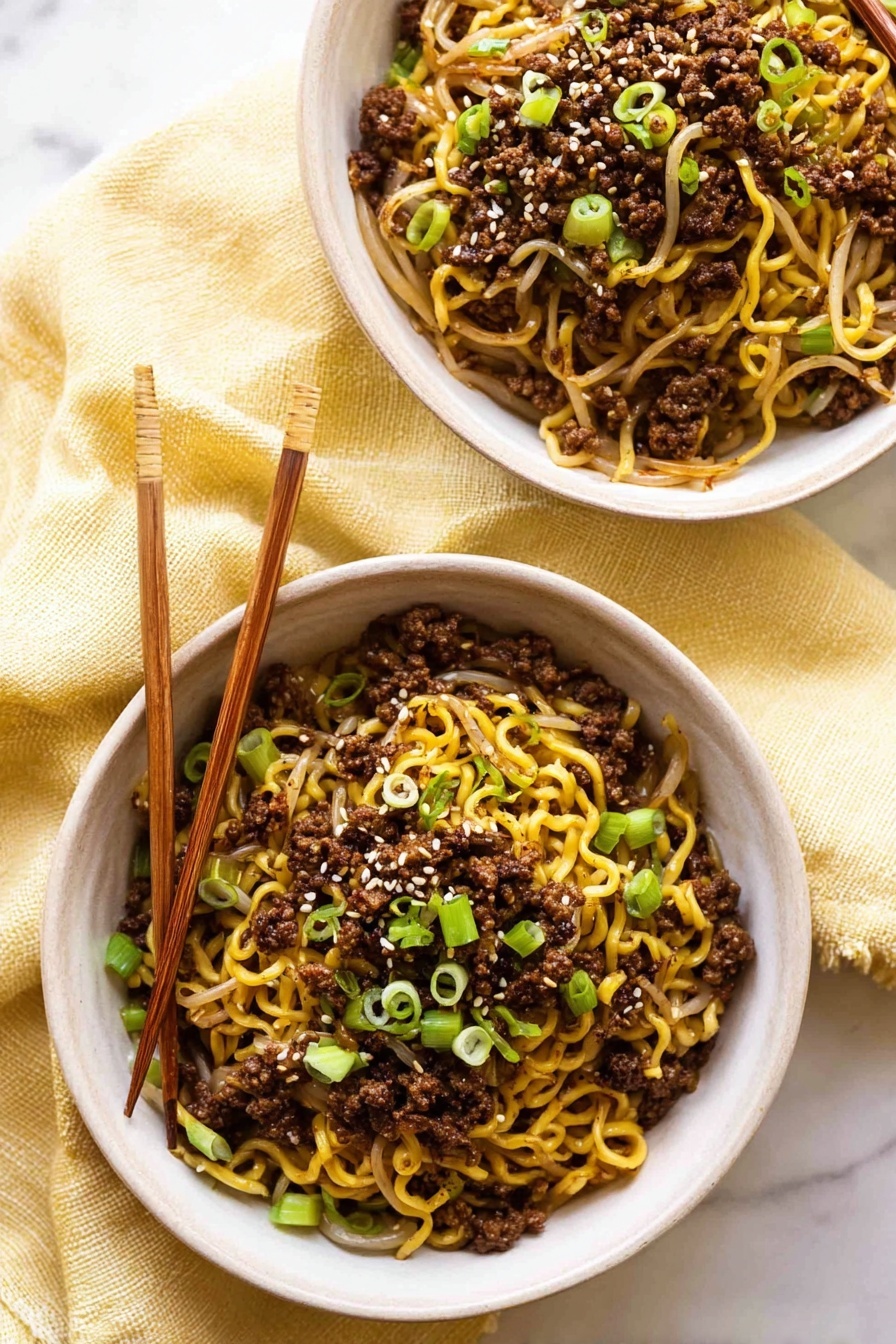Quick Asian Beef Ramen Noodles, Asian beef ramen recipe, easy beef ramen, speedy ramen dinner, flavorful beef noodle bowl - Two white bowls are filled with cooked yellow noodles mixed with dark brown ground meat and light brown bean sprouts. The noodles are topped with small, bright green chopped spring onions and a few white sesame seeds sprinkled on top. One bowl has light brown wooden chopsticks resting on its edge. The bowls sit on a soft, light yellow cloth, placed on a white marbled surface. photo taken with an iphone --ar 2:3 --v 7