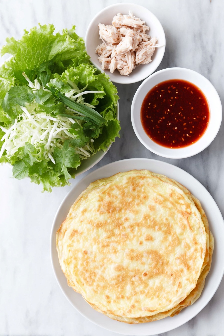 Crispy Asian Chicken Salad Wraps, Asian chicken wraps, crunchy chicken salad, Asian appetizer recipes, easy chicken wraps - Flat lay of a crisp stack of golden fried egg roll wrappers, a heap of fresh mixed Asian salad greens with shredded cabbage, a few whole cooked chicken tenders glistening with bright red sweet chili sauce, and a small white ceramic bowl filled with glossy sweet chili sauce, all arranged in perfect symmetry on a simple white ceramic plate and bowls, placed on a clean white marble surface, soft natural light, photo taken with an iPhone, professional food photography style, fresh ingredients, white ceramic bowls, no bottles, no duplicates, no utensils, no packaging --ar 2:3 --v 7 --p m7354615311229779997