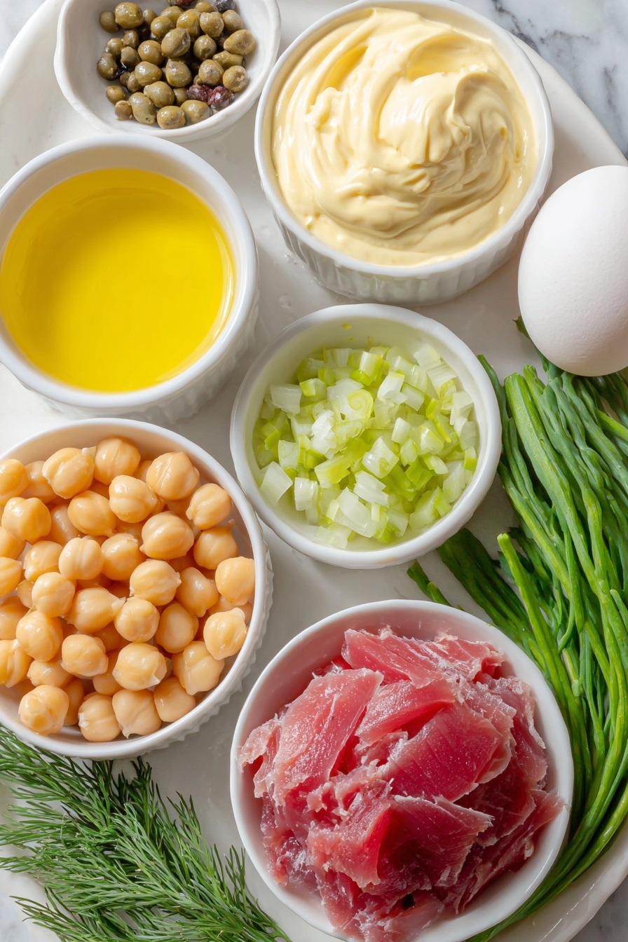 Healthy Tuna Chickpea Salad, Tuna Chickpea Salad, Healthy Lunch Recipes, Quick Healthy Salads, nutritious tuna salad - Flat lay of a small pile of shiny light beige chickpeas, a simple white ceramic bowl with creamy mayonnaise, a small white bowl of golden olive oil, a small white bowl with bright yellow fresh lemon juice, a small white bowl holding smooth dijon mustard, a few fresh green dill sprigs, a small heap of finely chopped pale green celery, a small amount of finely minced bright purple-red onion, a small mound of briny green capers, a small flaky pile of light pink tuna, a small white bowl with ground black pepper, and a whole clean white egg with uncracked shell, all arranged in perfect symmetry on a clean white ceramic plate and bowls, placed on a clean white marble surface, soft natural light, photo taken with an iPhone, professional food photography style, fresh ingredients, white ceramic bowls, no bottles, no duplicates, no utensils, no packaging --ar 2:3 --v 7 --p m7354615311229779997