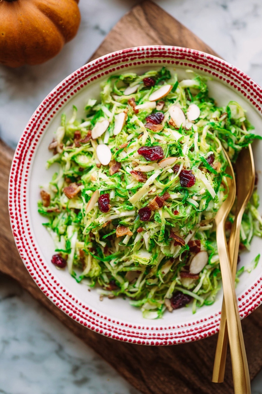 Brussels Sprout Kale Apple Salad, healthy fall salad, crunchy vegetable salad, easy healthy green salad, bacon and cheese kale salad - A wooden bowl filled with a shredded green salad showing thin layers of light green and pale yellow textures from the shaved Brussels sprouts. There are visible small pieces of dark red dried cranberries and bits of brown nuts mixed throughout the salad. Bright green leafy bits are scattered across all layers, adding a fresh and crisp look. Two gold forks rest inside the bowl, one leaning on the side. The bowl is placed on a white marbled surface with a few fresh Brussels sprouts and apples nearby, along with part of an orange checkered cloth. Photo taken with an iphone --ar 2:3 --v 7