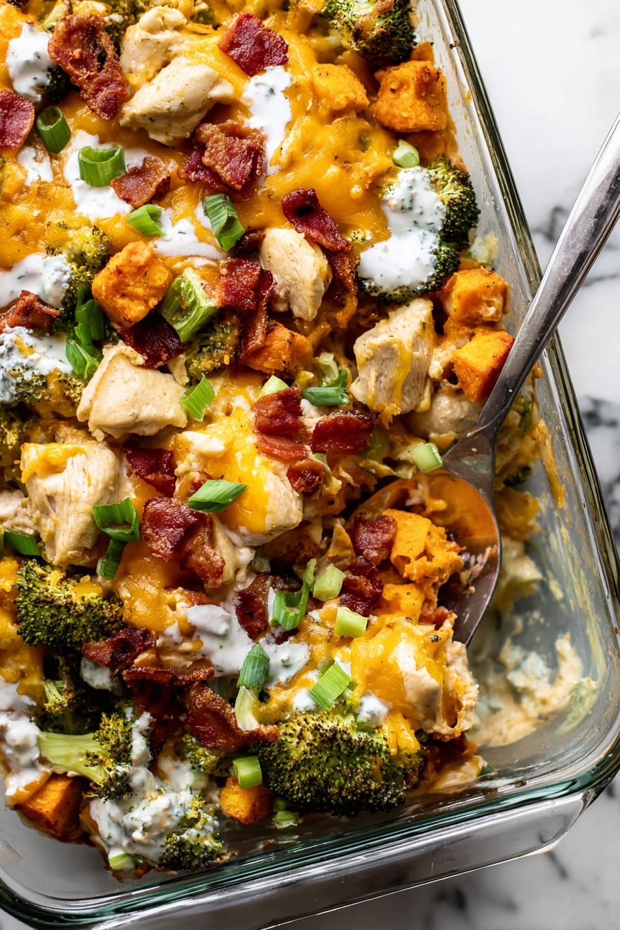 Buffalo Chicken Sweet Potato Casserole, buffalo chicken baked dish, spicy sweet potato casserole, healthy buffalo chicken dinner, cheesy buffalo chicken casserole - A clear glass baking dish filled with a colorful mix of food layers on a white marbled surface. The bottom layer is made of orange roasted cubes, likely sweet potatoes, topped with bright green roasted broccoli pieces. Large chunks of cooked white chicken pieces are scattered evenly on top of the vegetables. On the top layer, there are dark red crispy bacon strips breaking up the texture and sprinkled yellow shredded cheddar cheese adds a soft texture and color contrast. Around the dish, there are small white bowls filled with chopped green onions, more bacon strips, and an orange sauce. The overall look is warm and inviting with a mix of soft and crispy textures, set against the white marbled background. Photo taken with an iphone --ar 2:3 --v 7