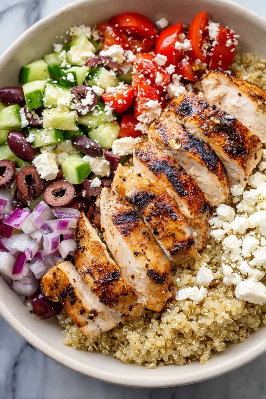 Greek Chicken Quinoa Bowl, healthy Greek bowl, Mediterranean chicken quinoa, bright and flavorful grain bowl, easy Greek-inspired dinner - A white bowl holds a colorful layered dish on a white marbled surface. The bottom layer is light beige quinoa. On top of this, sliced grilled chicken with visible char marks sits to one side. To the right of the chicken is a mix of chopped red tomatoes and small pieces of red onion. Below the tomato mix is chopped green cucumber with some purple olives scattered throughout. White crumbled cheese is sprinkled over the top of the tomatoes, cucumbers, and olives. The colors contrast well, showing fresh and healthy ingredients. Photo taken with an iphone --ar 2:3 --v 7