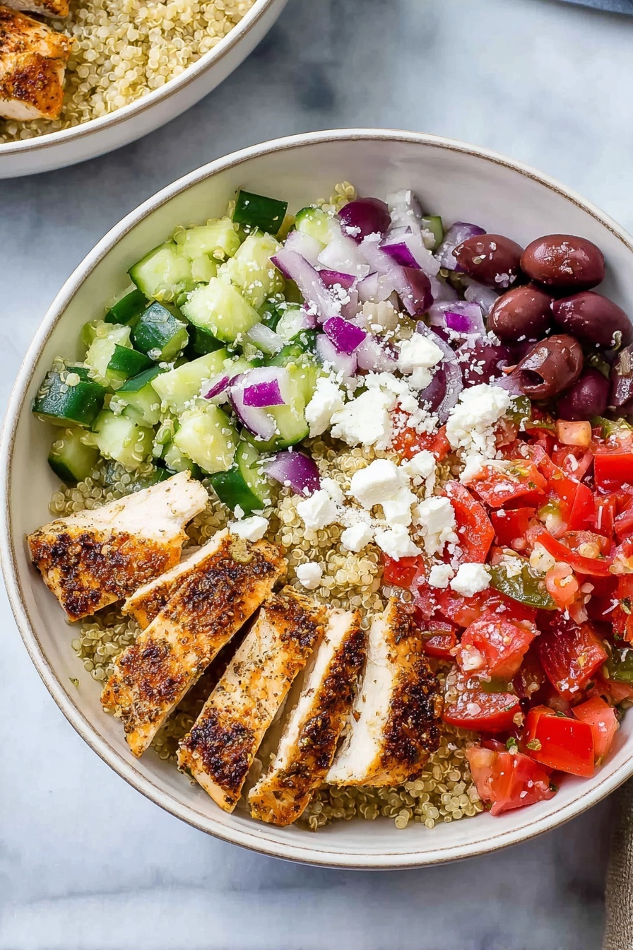 Greek Chicken Quinoa Bowl, healthy Greek bowl, Mediterranean chicken quinoa, bright and flavorful grain bowl, easy Greek-inspired dinner - The image shows a white bowl filled with a colorful healthy dish. At the center, there are four thick slices of grilled chicken with brown grill marks and a light golden color. Surrounding the chicken are four different sections: diced green cucumber mixed with black olives and crumbled white cheese, chopped red tomatoes mixed with small pieces of red onion and black olives, white crumbled cheese, and a base of light beige quinoa. The background is a white marbled surface. photo taken with an iphone --ar 2:3 --v 7