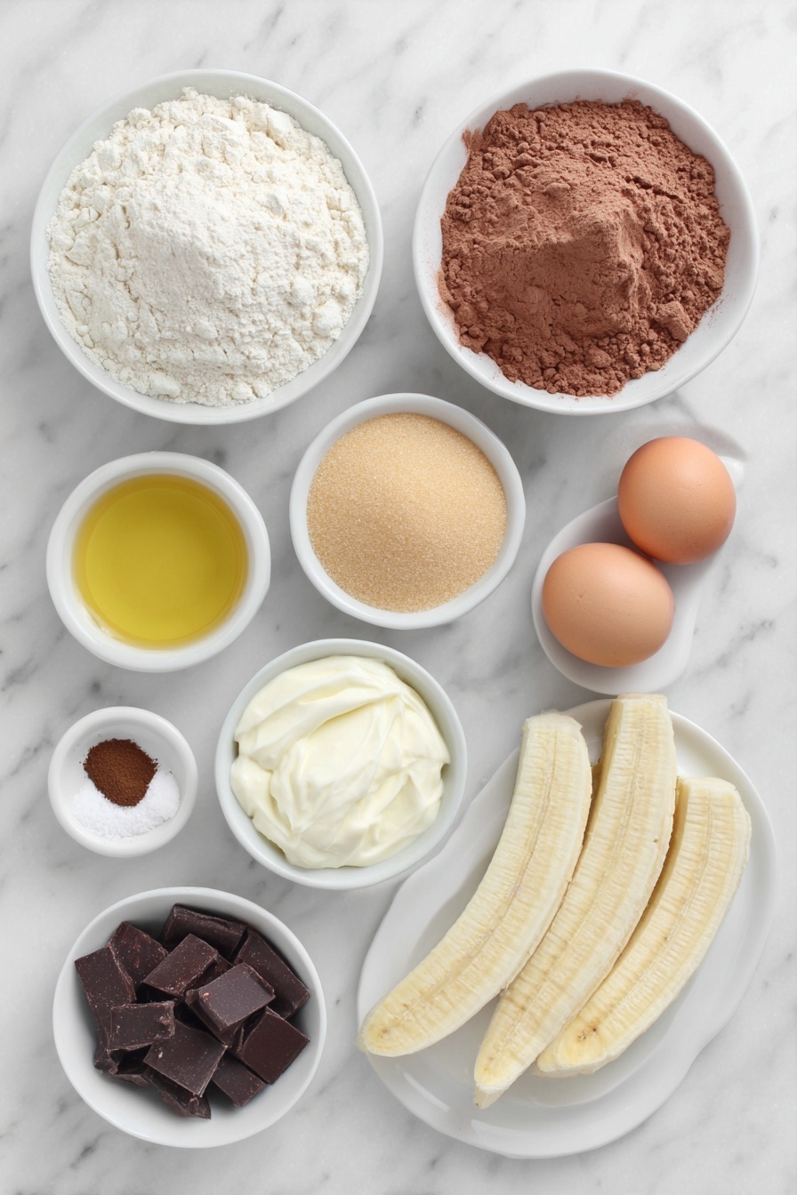 Chocolate Espresso Banana Bread, banana bread with espresso, moist banana bread, chocolaty banana bread, easy banana bread recipe - Flat lay of a small mound of all purpose flour, a small mound of cocoa powder, a teaspoon of fine espresso powder, a teaspoon of kosher salt, a teaspoon of baking soda, a small white bowl of golden olive oil, a small white bowl filled with light brown granulated sugar and another small white bowl with white granulated sugar, two whole uncracked brown eggs with clean shells, a small white bowl of sour cream, a small plate with three ripe peeled bananas, a small white bowl with dark chocolate chips, another small white bowl with semi sweet chocolate chips, two long thin banana slices on a simple white ceramic plate arranged neatly beside the bowls, all ingredients arranged symmetrically and proportionally, placed on a clean white marble surface, soft natural light, photo taken with an iPhone, professional food photography style, fresh ingredients, white ceramic bowls, no bottles, no duplicates, no utensils, no packaging --ar 2:3 --v 7 --p m7354615311229779997